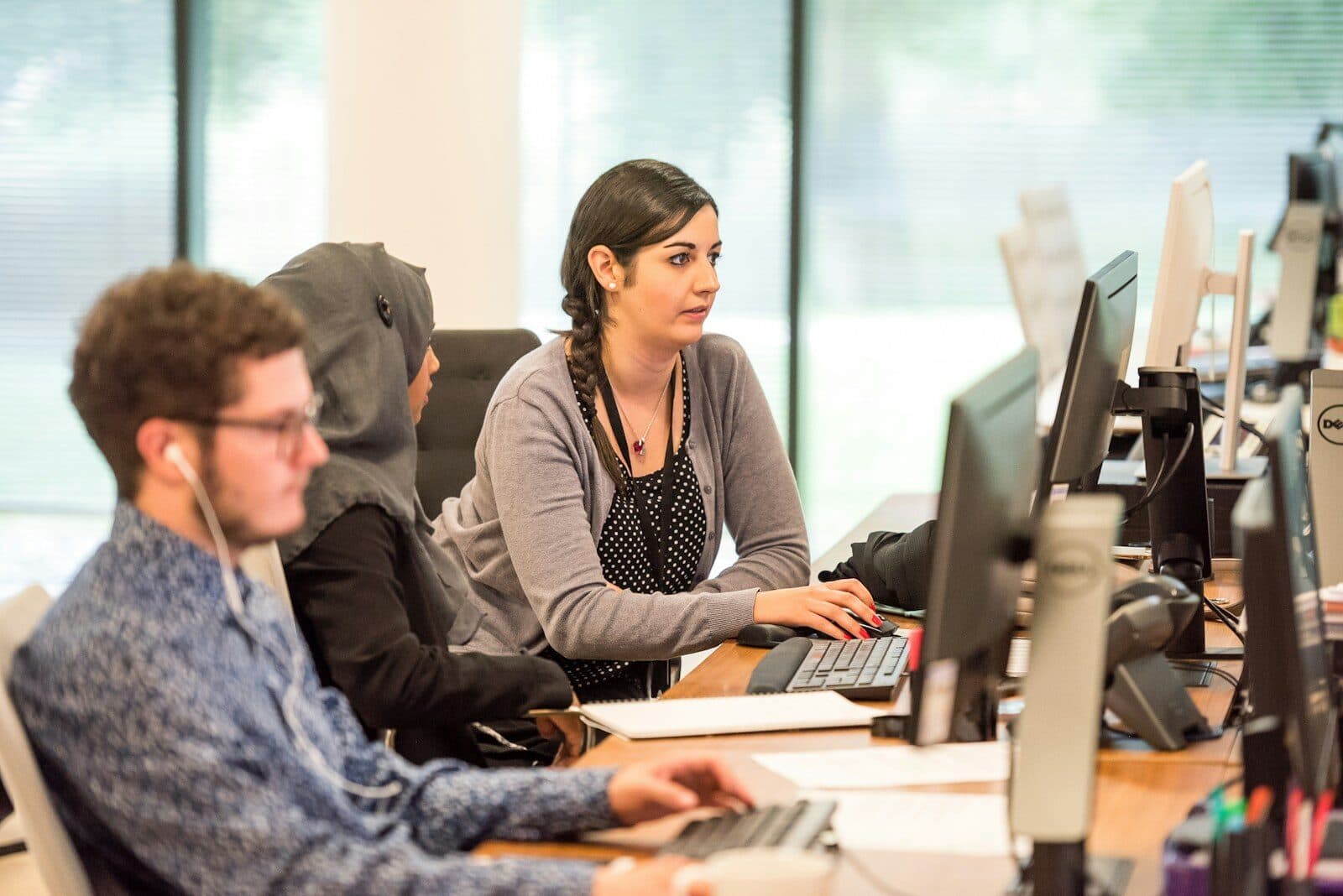 Customer support staff working at computers in an open office