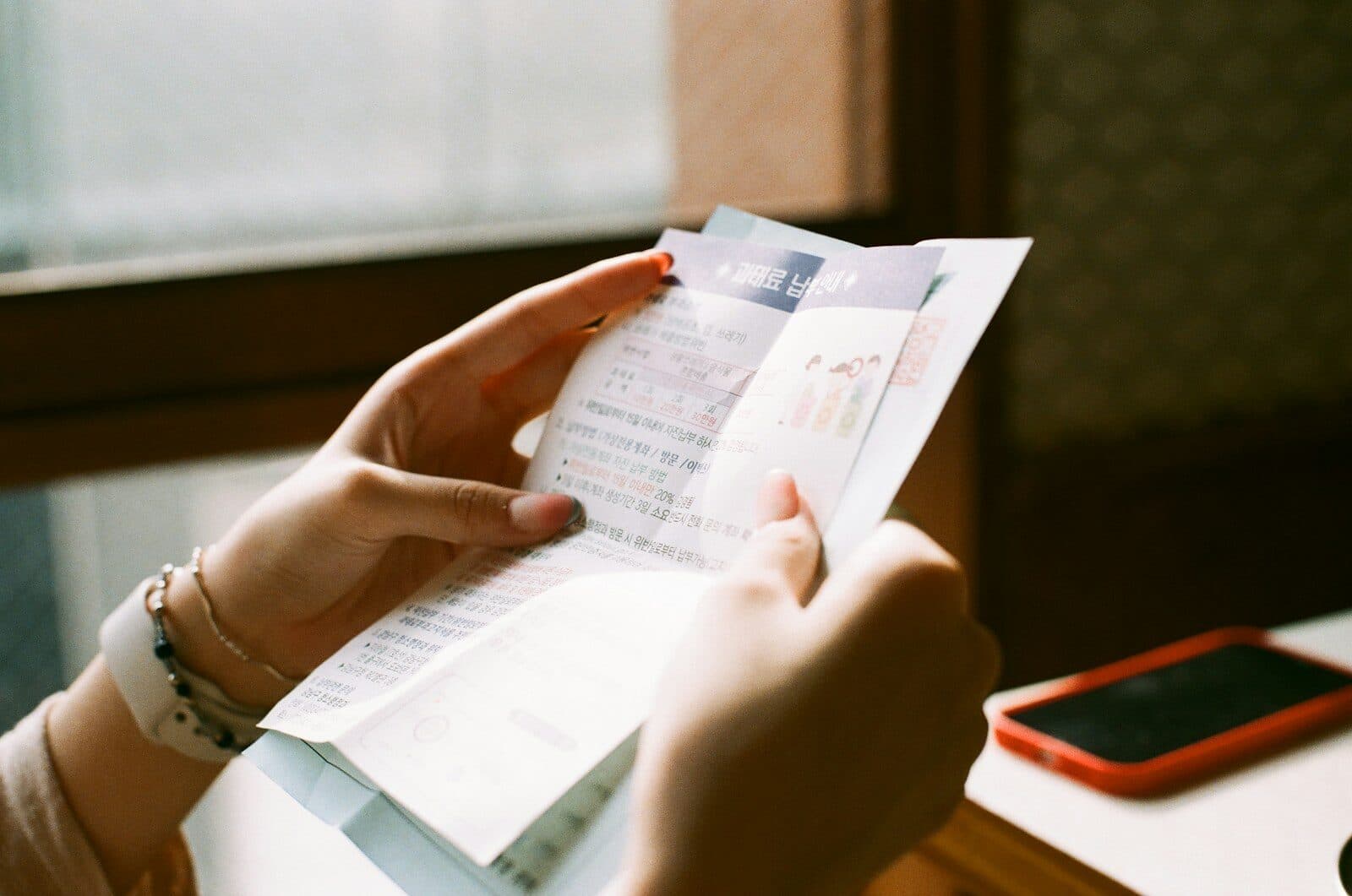 Hands holding a printed receipt