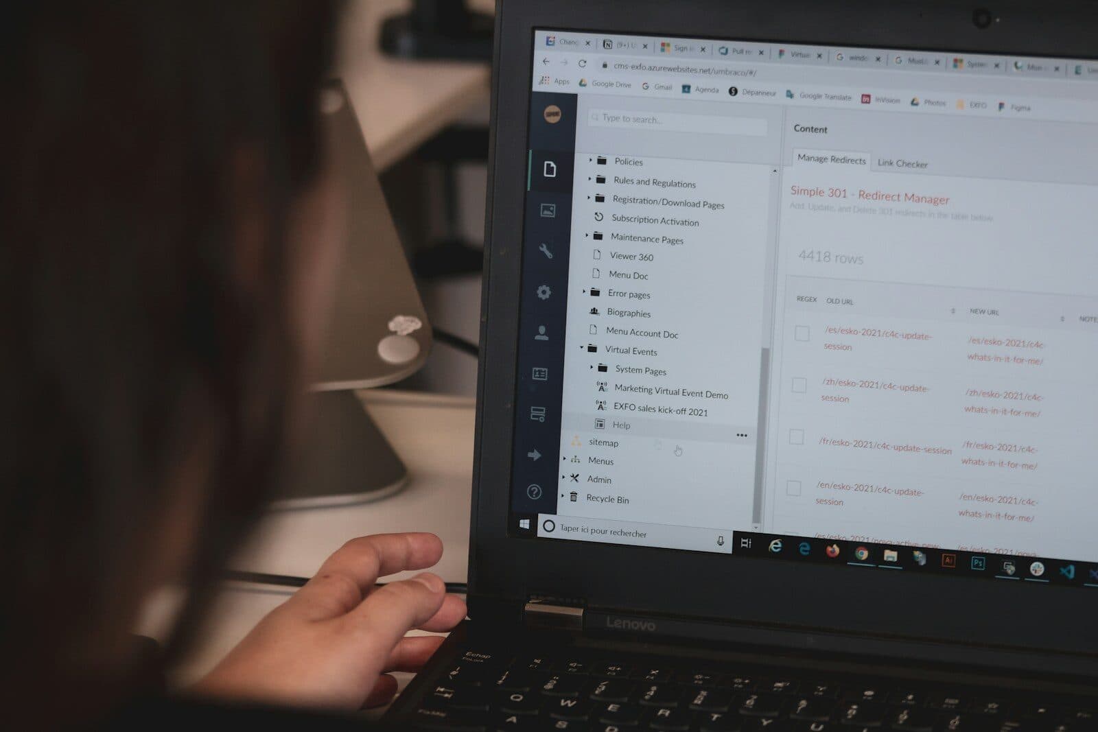 A person working on a laptop in a dim room